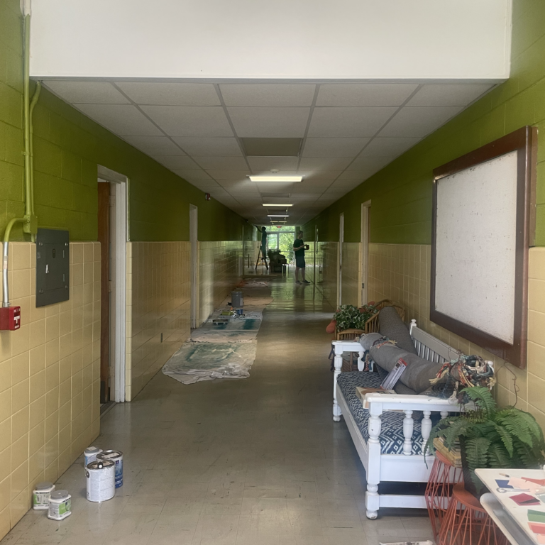 the entry way of church street studios leading to the hall way, painted green